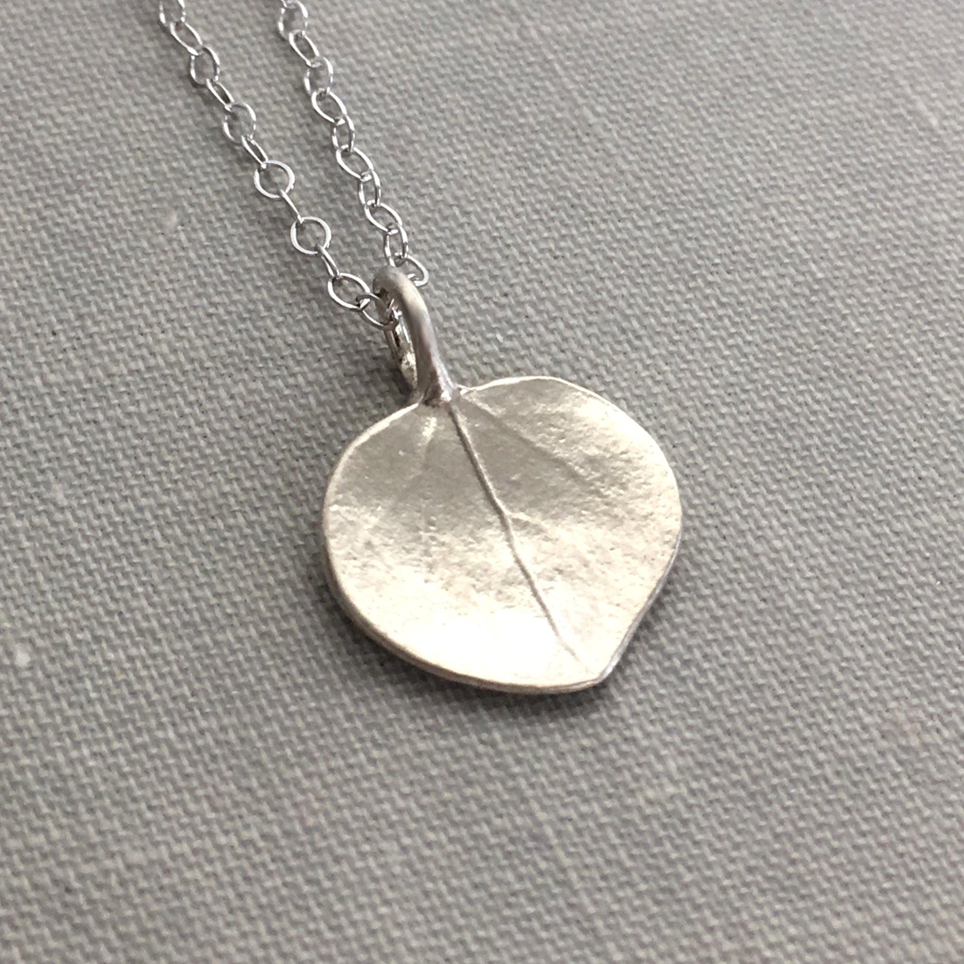 Pendant with small silver and gold leaf dome on silver chain